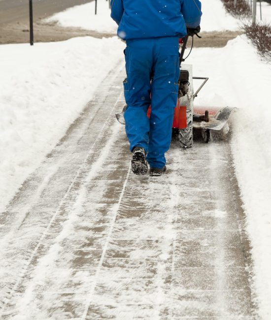 Snow blower Man working with a snow blowing machine