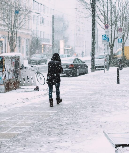 rear-view-woman-walking-sidewalk-snowfall-city rear-view-woman-walking-sidewalk-snowfall-city